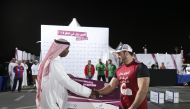 Abdullah Al Khater, Manager of Events at Aspire Zone Foundation, congratulates  one of the participants during the 2014 Qatar's Strongest Man competition in this file photo. 