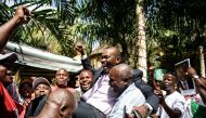 (FILES) This file photo taken on May 15, 2015 shows presidential spokesperson Willy Nyamitwe (C) being carried by supporters as people celebrate the return of the Burundian president after a failed coup attempt in the Kamenge quarter of Bujumbura, a rulin