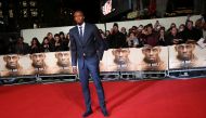 Athlete Usain Bolt (C) poses for photographers at the world premiere of the film 