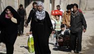 Iraqis flee, from their neighberhood in the eastern district of Mosul to a safe area, on November 29, 2016, during an ongoing operation against Islamic State (IS) group jihadists. AFP / THOMAS COEX