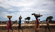 People walk through the UN base outside Bentiu, South Sudan, September 17, 2015. (AFP  / Tristan McConnell) 