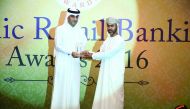 QIIB Deputy CEO Jamal Al Jamal (left) receiving the award at the event held in Dubai.