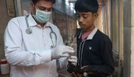 In this photograph taken on November 4, 2016, Dr Dheeraj Kumar Singh (L) checks a sick bird at the Charity Birds Hospital in the old quarters of New Delhi. AFP / Dominique Faget 