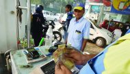 A customer pays for fuel with old 500 rupee notes at a petrol station in New Delhi, yesterday. 
