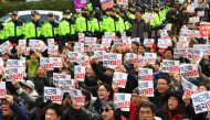 South Korean protesters shout slogans during a protest outside the ruling Saenuri Party in Seoul on December 3, 2016.  AFP / JUNG Yeon-Je
