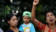 A woman carrying her son watches as a local protests against the visit by former U.N. Secretary-General Annan in Rakhine state. File photo 
Image by: SOE ZEYA TUN / REUTERS