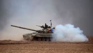 Iraqi Shiite fighters from the Hashed al-Shaabi (Popular Mobilisation) paramilitaries manoeuver a T-72 tank as they advance near the village of Tal Abtah, south of Tal Afar, on November 30, 2016, during a broad offencive by Iraq forces to retake the city 