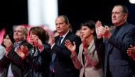 French Socialist Party First Secretary Jean-Christophe Cambadelis (C) gives Francois Hollande standing ovation during the convention of the Belle Alliance Populaire (Nice Popular Union), a gathering aiming at uniting democrats, socialists, ecologists, int