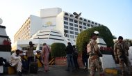 Guests are gather outside a Regent Plaza Hotel following a fire in the Pakistan's port city of Karachi on December 5, 2016. AFP / RIZWAN TABASSUM
