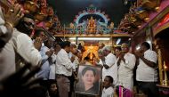 Well wishers of Tamil Nadu Chief Minister Jayalalithaa Jayaraman hold her portrait as they pray at a temple in Mumbai, India, December 5, 2016. REUTERS/Danish Siddiqui
