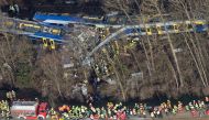 (FILES) This file photo taken on February 9, 2016 shows firefighters and emergency doctors working at the site of a train accident near Bad Aibling, southern Germany. A German court on December 5, 2016 sentenced a rail dispatcher to three and a half years
