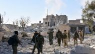 Syrian pro-government forces patrol the Masaken Hanano district in eastern Aleppo, November 27, a day after regaining control of the area from rebels. / AFP.