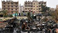 A Russian soldier inspects the damage at a field hospital that was reportedly destroyed by rebel shelling on December 5, 2016 in the Furqan neighborhood of the government-held side of west Aleppo. AFP / GEORGE OURFALIAN