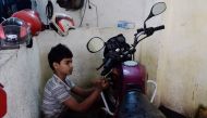 Bangladeshi worker Russel, and who says he will turn 14 next year, works in a garage in Dhaka on December 7, 2016.  AFP / MUNIR UZ ZAMAN