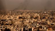 A general view taken from Aleppo's citadel show fumes rising following shelling on neighbourhoods in the old city on December 7, 2016. AFP / GEORGE OURFALIAN