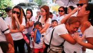 The wife and other relatives of Florjohn Cruz, who was killed in a police drugs buy-bust operation, cry as his coffin leaves their home for his funeral in Manila, Philippines October 30, 2016. REUTERS/Damir Sagolj

