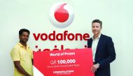 Vodafone's Luke Longney (right) handing over the prize.