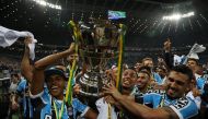 Players of Gremio celebrate with the Copa do Brasil trophy. REUTERS/Diego Vara