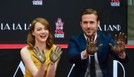 Actors Emma Stone and Ryan Gosling display their hands after placing them into the block of cement at their Hand and Foot prints ceremony in front of the TCL Chinese Theater in Hollywood on December 7, 2016 ahead of the release of the film LA LA Land set 