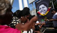 Supporters of Tamil Nadu Chief Minister Jayalalithaa Jayaraman light candles in front of her picture as they pay homage outside Jayalalithaa's burial site in Chennai, India, December 7, 2016. REUTERS/Adnan Abidi
