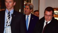 US Secretary of State John Kerry (C) arrives ahead of the two-day foreign ministers' meeting of the Organisation for Security and Cooperation in Europe (OSCE) in Hamburg, northern Germany, on December 7, 2016. / AFP / John MACDOUGALL
