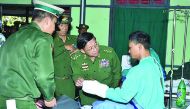 Myanmar Armed Forces chief Senior General Min Aung Hlaing meets a wounded soldier recovering at a military hospital in Lashio, located in Shan State.