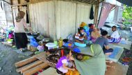 Villagers rest outside their houses which were damaged after an earthquake in Kuta Pangwa village in Pidie Jaya, yesterday.