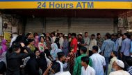 People queue outside a bank to withdraw cash and deposit their old high denomination banknotes in Mumbai, India, December 2, 2016. REUTERS/Danish Siddiqui/File Photo