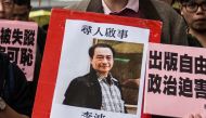 FILE PHOTO: A protestor holding up a missing person notice for Lee Bo 65 as they walk towards China Liaison Office in Hong Kong, January 3, 2016 (AFP / ANTHONY WALLACE) 