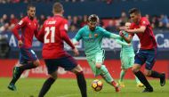 Barcelona's Argentinian forward Lionel Messi (C) vies with Osasuna's defender David Garcia during the Spanish league football match CA Osasuna vs FC Barcelona at the Reyno de Navarra (El Sadar) stadium in Pamplona on December 10, 2016. (AFP / Cesat Manso)