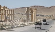 Syrian army soldiers drive past the Arch of Triumph in the historic city of Palmyra, in Homs Governorate, Syria in this April 1, 2016 file photo. Reuters/Omar Sanadiki/File Photo