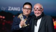 Chinese director Zang Qiwu (L) receives the Golden star for the film 