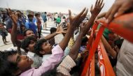 Displaced residents raise their hands to receive free food distributed by volunteers in the flood-affected areas of Chennai, India, December 3, 2015. REUTERS/Anindito Mukherjee