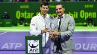 The defending champion and world number two Novak Djokovic (left) of Serbia receives the 2017 QatarExxon Mobil Open award from  Tournament Director Karim Alami in this file photo.