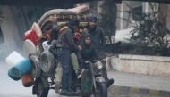 Men ride a tricycle as they flee deeper into the remaining rebel-held areas of Aleppo, Syria December 7, 2016. REUTERS/Abdalrhman Ismail
