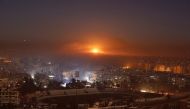 Smoke and flames rise after air strikes on rebel-controlled besieged area of Aleppo, as seen from a government-held side, in Syria December 11, 2016. REUTERS/Omar Sanadiki