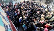 Civilians wait outside a government military police centre to visit their relatives, who were evacuated from the eastern districts of Aleppo and are being prepared to begin their military service, in Aleppo, Syria December 11, 2016. REUTERS/Omar Sanadiki