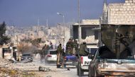Syrian pro-government forces patrol Aleppo's Sheikh Saeed district, on December 12, 2016, after troops retook the area from rebel fighters. / AFP / GEORGE OURFALIAN