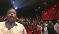 Moviegoers in New Delhi stood for the national anthem before a screening Dec. 4. A Supreme Court ruling requires viewers to stand respectfully while the anthem is played, unless they are physically unable. Credit Chandan Khanna/Agence France-Presse.