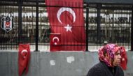 A woman stands in front of Turkish national flags that are displayed at the site of the December 10 blasts outside Besiktas' Vodafone Arena football stadium on December 13, 2016 in Istanbul.
Twin blasts hit Istanbul on December 10, 2016 killing 37 police