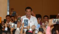 Philippine President Rodrigo Duterte greets people before a meeting with the Filipino Community at a hotel in Phnom Penh, December 13, 2016. REUTERS/Samrang Pring