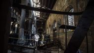 Egyptian security forces inspect the scene of a bomb explosion at the Saint Peter and Saint Paul Coptic Orthodox Church on December 11, 2016, in Cairo's Abbasiya neighbourhood. The blast killed at least 25 worshippers during Sunday mass inside the Cairo c