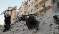Free Syrian Army fighters fire their weapons during what the FSA said were clashes with forces loyal to Syria's President Bashar al-Assad in Aleppo's Karm al-Jabal district October 15, 2013. REUTERS/Mohamed Mounzer Masri
