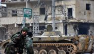 Syrian pro-government forces patrol the northern embattled city of Aleppo on December 14, 2016. Shelling and air strikes sent terrified residents running through the streets of Aleppo as a deal to evacuate rebel districts of the city was in danger of fall