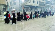 Syrian residents, fleeing violence in the restive Bustan Al Qasr neighbourhood, arrive in Aleppo's Fardos, after regime troops retook the area from rebel fighters, yesterday.