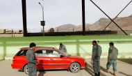 Afghan policemen inspect passengers at a Kabul entrance gate checkpoint in Kabul, Afghanistan December 7, 2016. REUTERS/Mohammad Ismail
