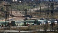 Buses and ambulances wait to evacuate civilians and rebels from eastern Aleppo, Syria December 15, 2016. REUTERS/Omar Sanadiki
