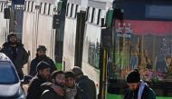 Men react as they stand outside buses evacuating people from a rebel-held sector of eastern Aleppo, Syria December 15, 2016. REUTERS/Abdalrhman Ismail
