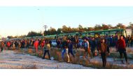 Evacuees from rebel-held east Aleppo, disembark from buses upon their arrival at the town of Al Rashideen