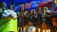 Residents hold lighted candles during a ceremony in Lahore yesterday to pay tribute to victims on the second anniversary of an attack on the Army Public School in Peshawar.